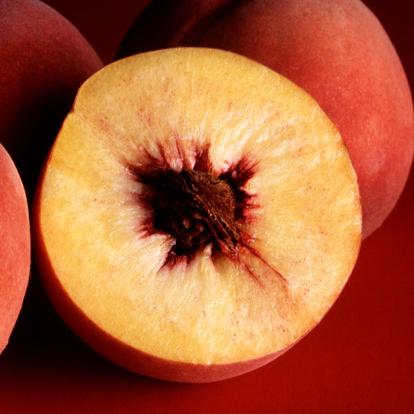 Representative photo of ripe yellow peaches, whole and cut, not Redstar itself