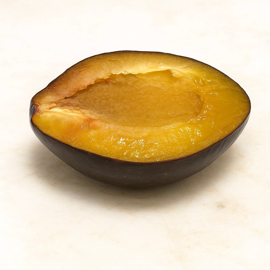 A Longjohn plum halved to show its deep amber flesh