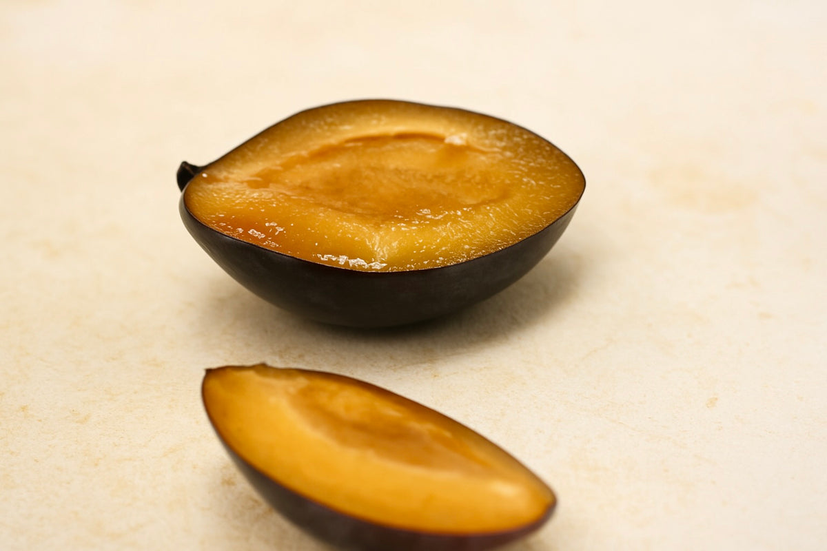Longjohn plum halves showing the flesh and stone cavity