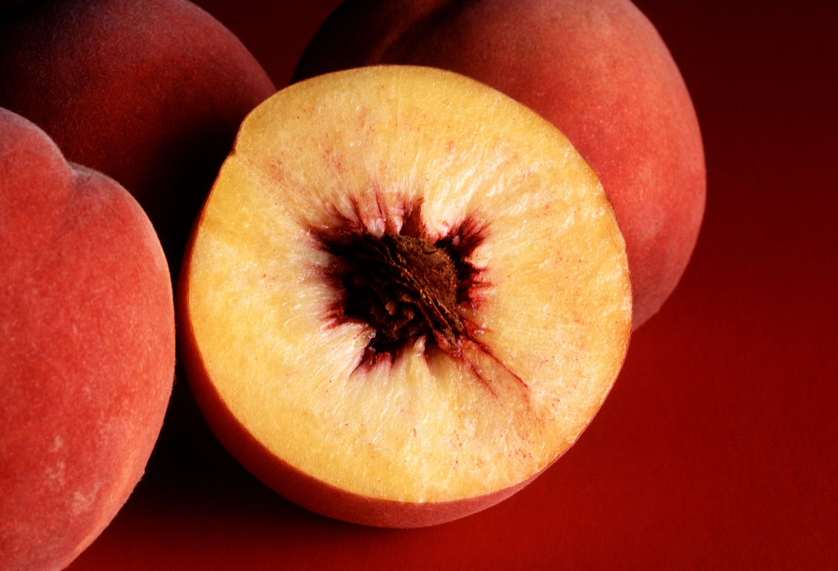 Representative photo of ripe yellow peaches, whole and cut, not Redstar itself